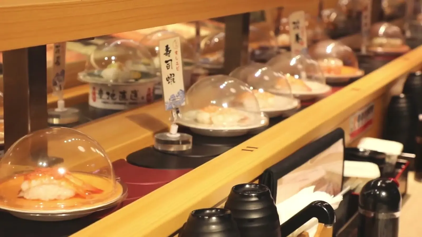 带盖板的链式传送带,菜品在传送带前流动